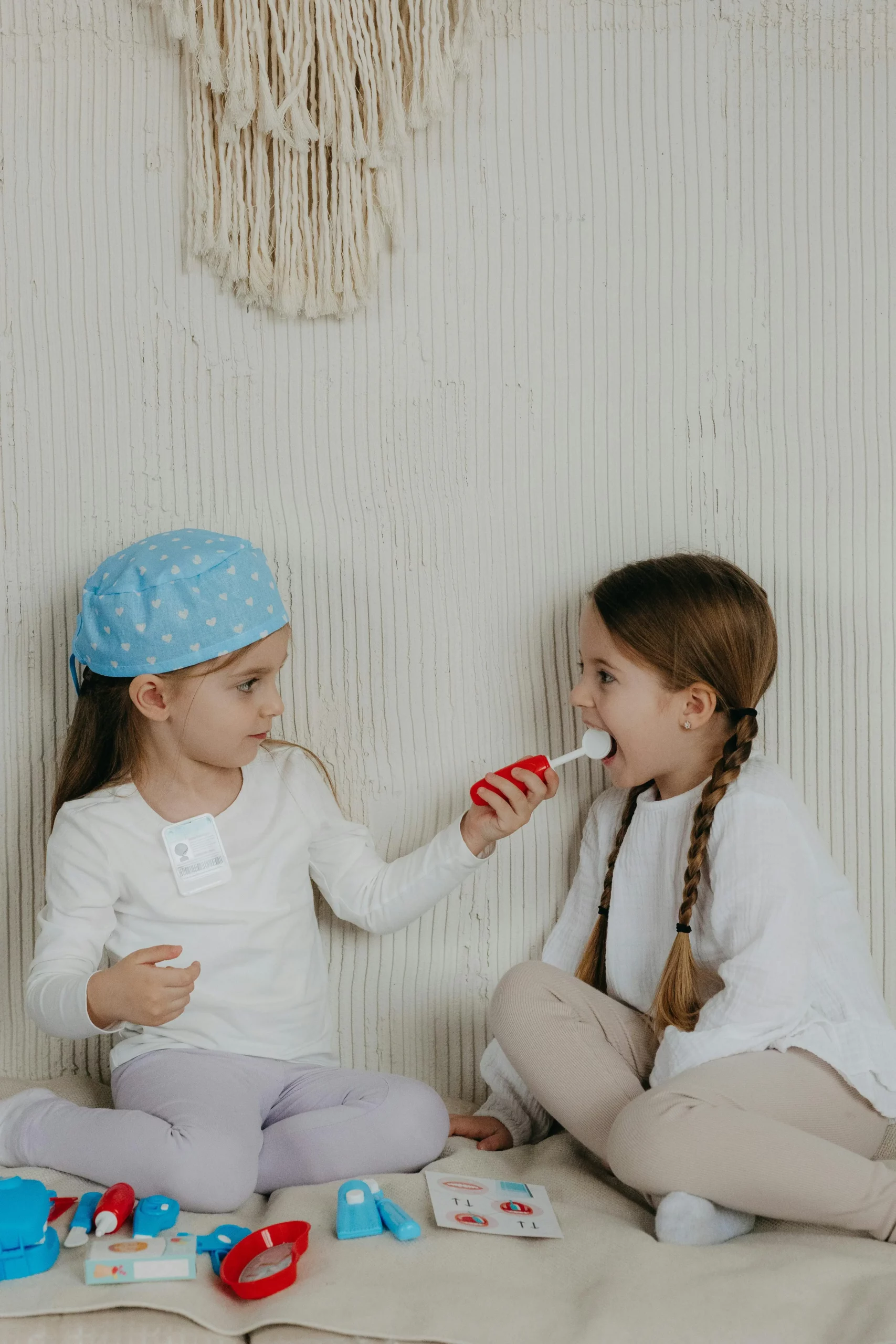 Zwei Kinder lernen spielerisch Kinderzahnarzt Besuch